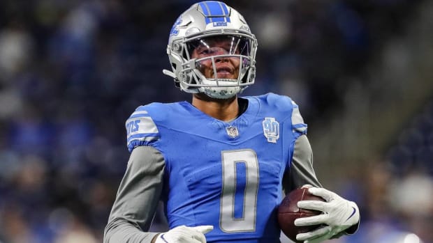 Lions wide receiver Marvin Jones carries a ball during warmups before a game.